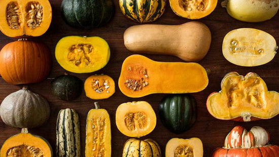 A table full of different winter squash varieties. 